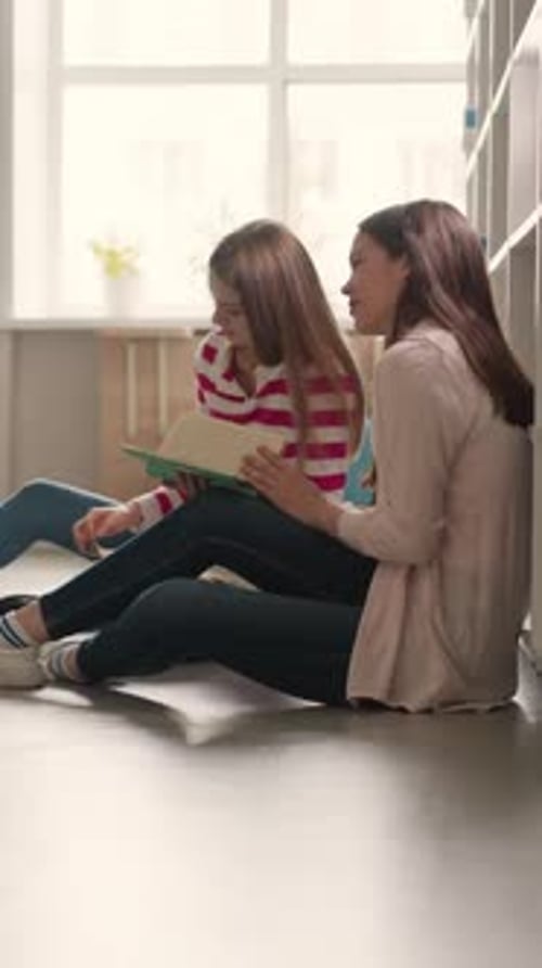 Young People Rest on Floor in Library