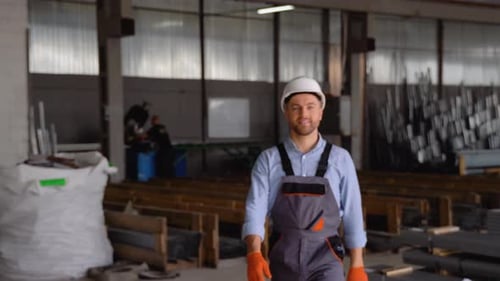 Cheerful Man in Hardhat Smiles in Warehouse