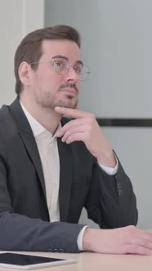 Thoughtful Man in Suit Leaning on Hand