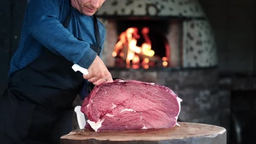 Chef Cuts Large Piece of Beef With Knife