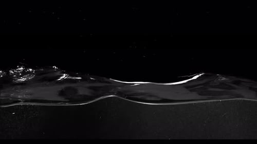 Submerge Collection: Calm waves of water moving slowly over a black background