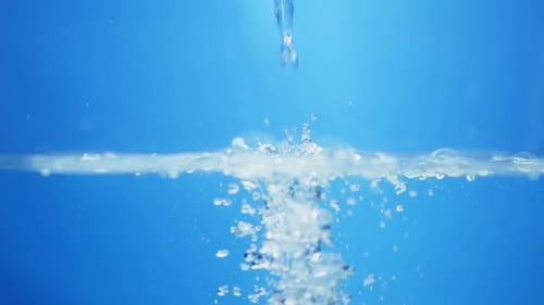 Bubbles Rising in Clear Water on Blue Background