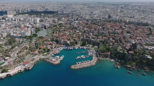 Old Town Marina and Moored Boats Tilt Up Reveal of Cityscape Large City with Various Buildings in