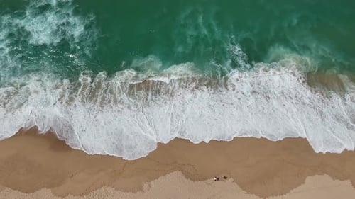 Stunningly Beautiful Aerial Views Capturing Waves and the Sandy Beach Below From Above