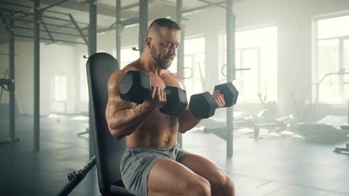 Muscular Man Lifting Weights in a Bright Gym