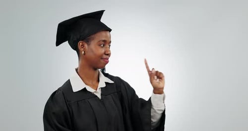 Graduation, woman and student pointing finger in studio for school and education advertising