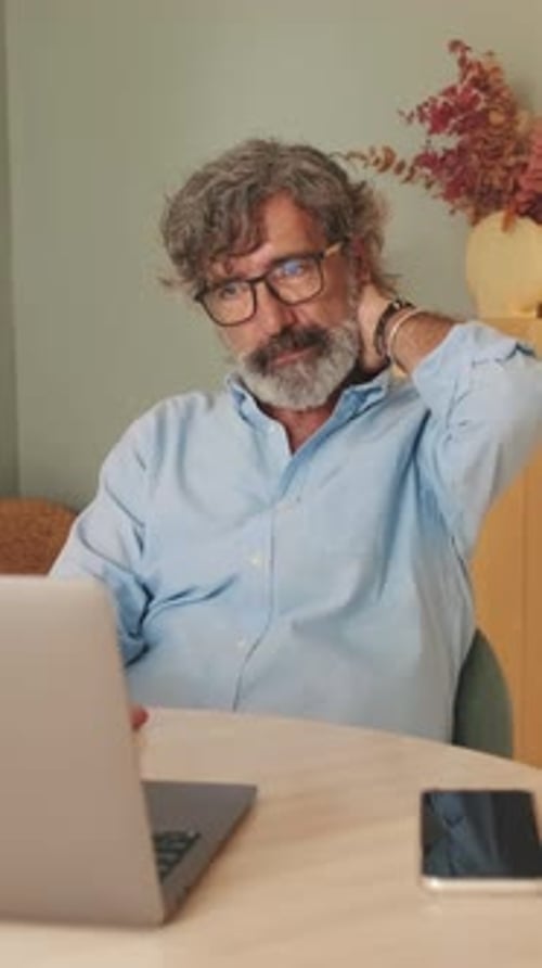 Man Working On Laptop At Table
