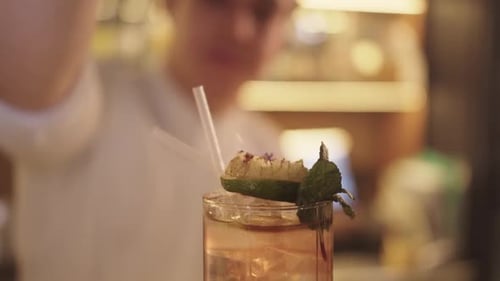Bartender Ignites Garnish on a Cocktail Glass