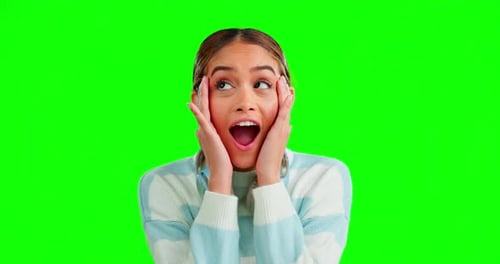 Woman, happy and shock face by green screen studio background with funny moment, wow and open mouth