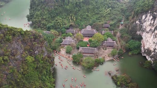 Trang An limestone mountains and river with boats in Ninh Binh Vietnam aerial view