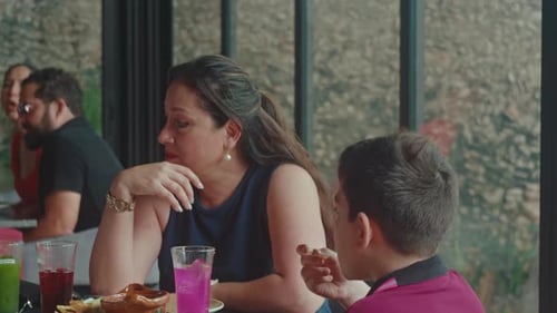 Woman and Child Chatting at Lunch in Restaurant