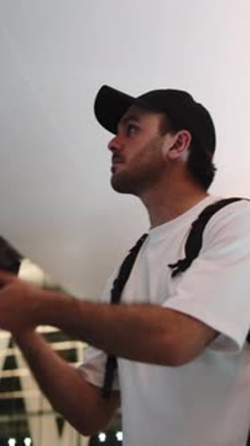 Travel Photographer Exploring a Modern Building with His Camera