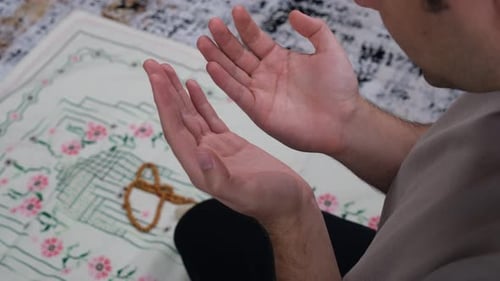Man Praying Devoutly on Prayer Mat Indoors