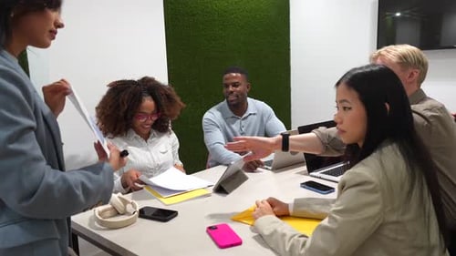 Coworkers Discussing Business Strategy in Modern Office