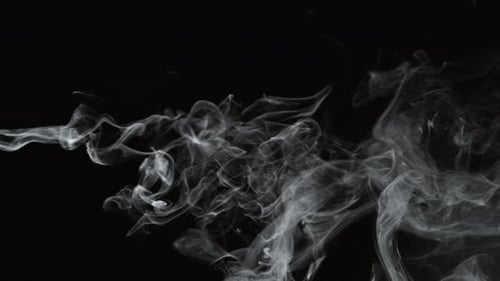 Wispy abstract smoke on black background for compositing