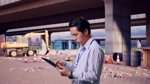 Asian Male Worker Use Tablet And Headache At Building Site
