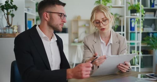 Business Colleagues Discuss Project in Office