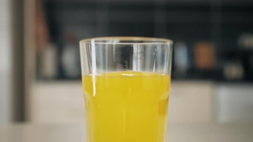 Refreshing Glass of Bright Yellow Juice Drink