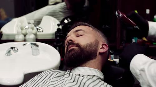 Man Getting a Haircut and Beard Trim at Barbershop