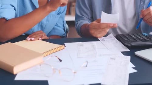 Close Up Hands Colleagues Sits at Table with Cashier Checks and Using Calculator