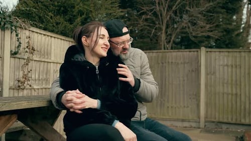 Loving Couple Embrace Outdoors Sitting Together