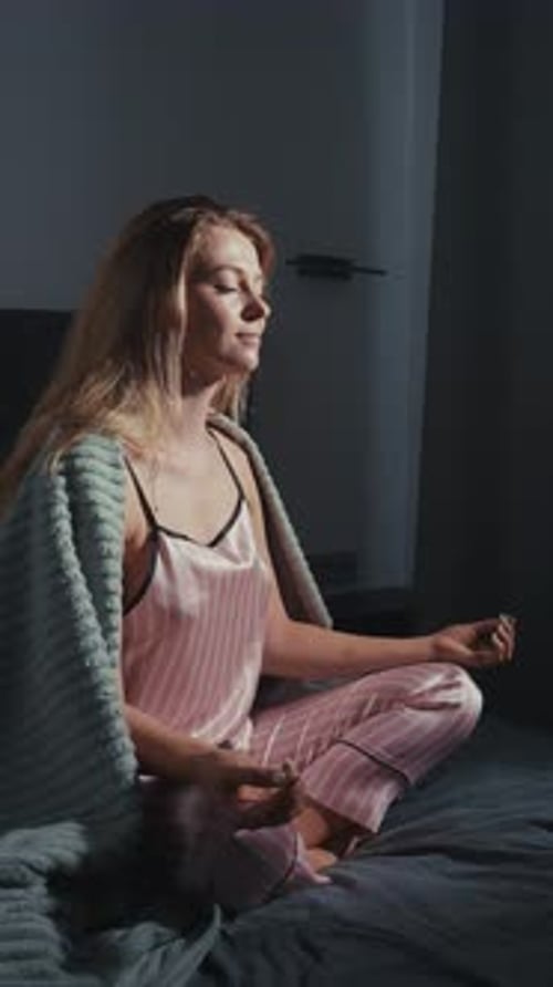 Woman Meditating in Peaceful Bedroom