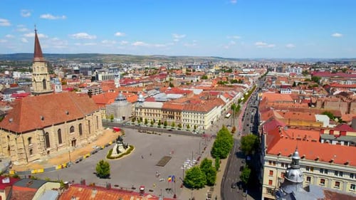 Aerial drone view of Cluj centre, Romania. Cityscape, walking people, road with cars, old buildings,
