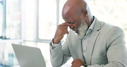 Corporate, laptop and black man with headache, burnout and overworked in modern office