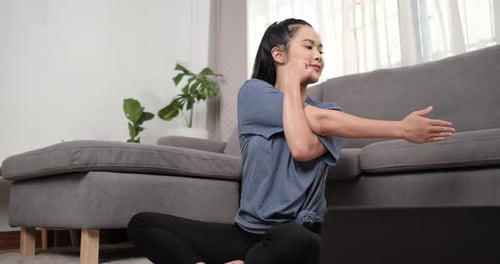 Woman Stretching Her Shoulder Indoors at Home