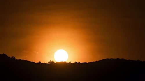 Bright Golden Sunrise Over Dark Hills Silhouette