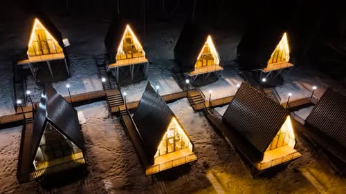 A Frame cabins at night in the winter park