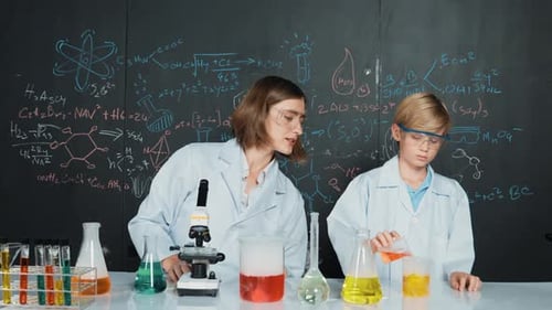 Woman and Boy Doing Science Experiment with Colorful Liquids