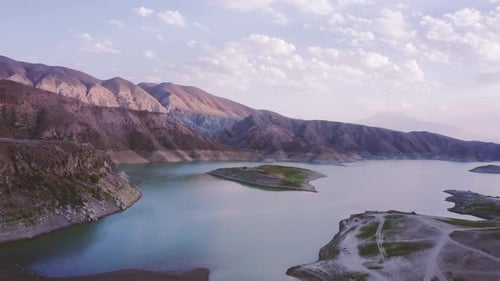 Breathtaking aerial view on a beautiful lake surrounded by mountains lit by a summer sunset sky in A