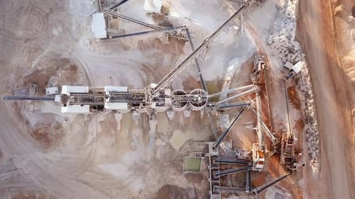 Stone sorting station in a large Quarry, with rocks transported on conveyor belts, Aerial view.