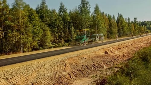 Building of concrete cement road over dirt road in forest time lapse