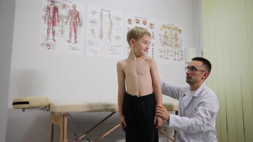 A Pediatric Healthcare Doctor is Conducting a Thorough Checkup on a Young Boy in a Medical Clinic