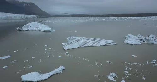 Icebergs Floating In Jokulsarlon Lake With Vatnajökull National Park In Iceland. - aerial