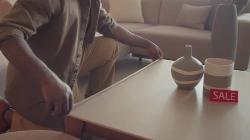 Potential Buyer Measuring Coffee Table in Furniture Store