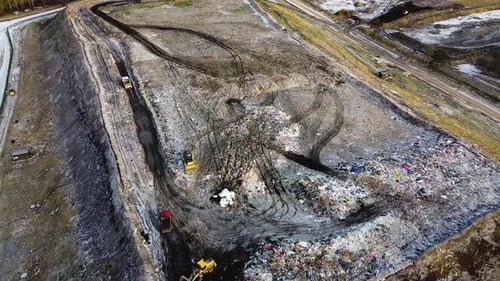 Aerial flyover landfill full of trash, pollution environmental problem, garbage, trucks dump waste p