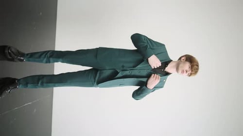 Man in green suit and black shirt