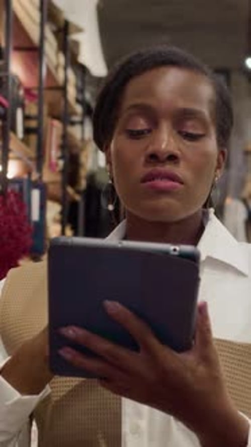 Female Store Worker Using Digital Tablet