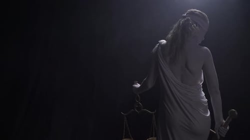 Statue of Lady Justice in Dramatic Lighting