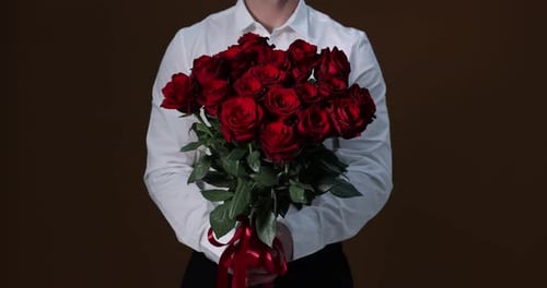 Man in Shirt Holding Bouquet of Red Roses