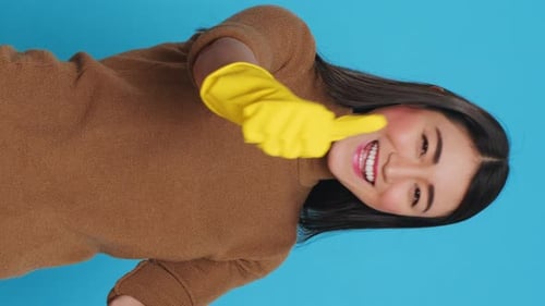 Smiling Woman in Sweater Points at Viewer
