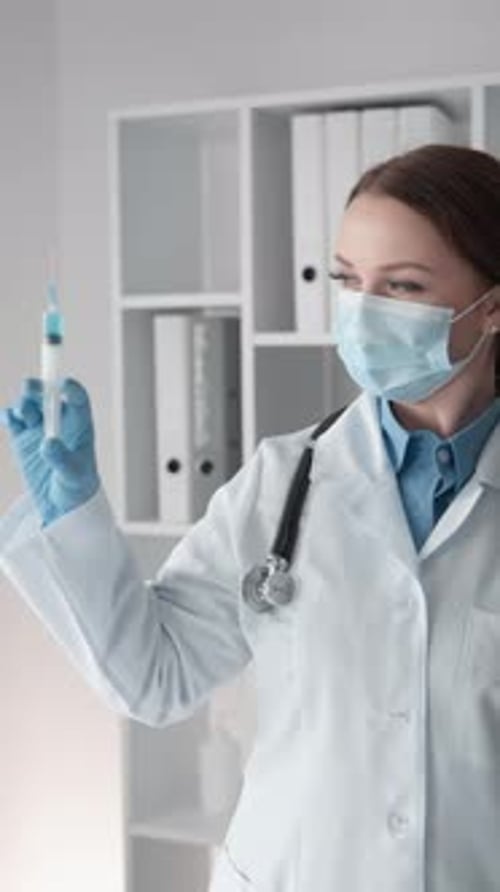 Woman Medical Professional Holding Syringe in Hospital