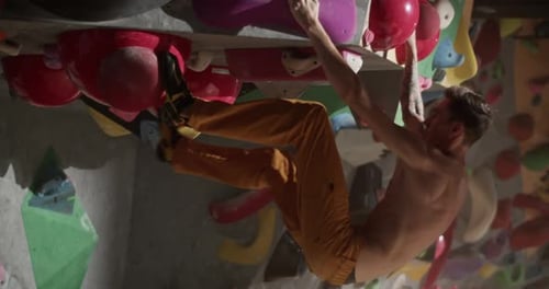 Man Climbing on Indoor Rock Climbing Wall