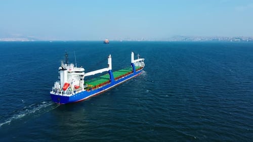 Cargo Ship Sails on the Blue Ocean