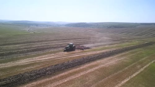 Tractor working on the field doing tillage with cultivator
