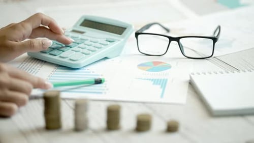 A Woman is Calculating Her Expenses for a Month