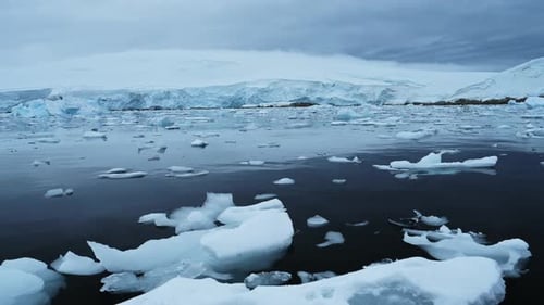 Serene Arctic Waters Filled With Floating Ice Near Massive Glacial Walls